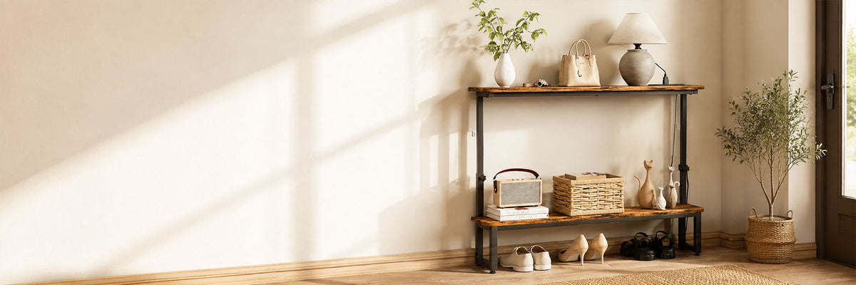 A rustic industrial-style wooden console shelf with black metal legs, styled with home decor items including a lamp, potted plants, baskets, and a small radio, set against a warm beige wall with soft window shadows.